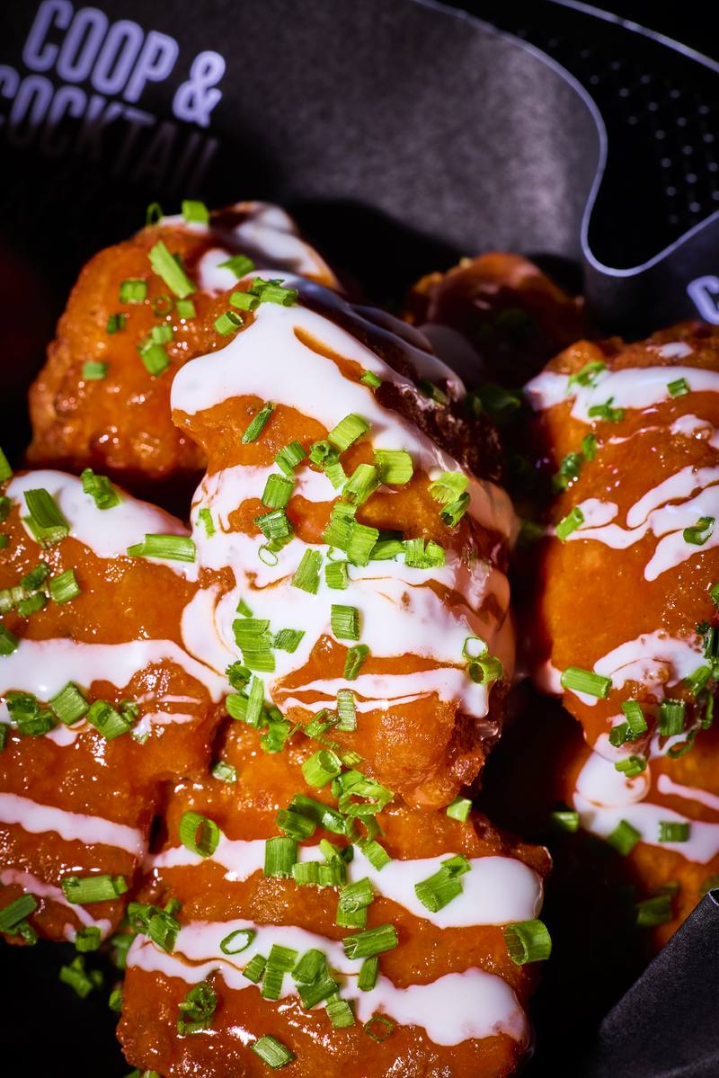 Close-up of buffalo wings with ranch and chives
