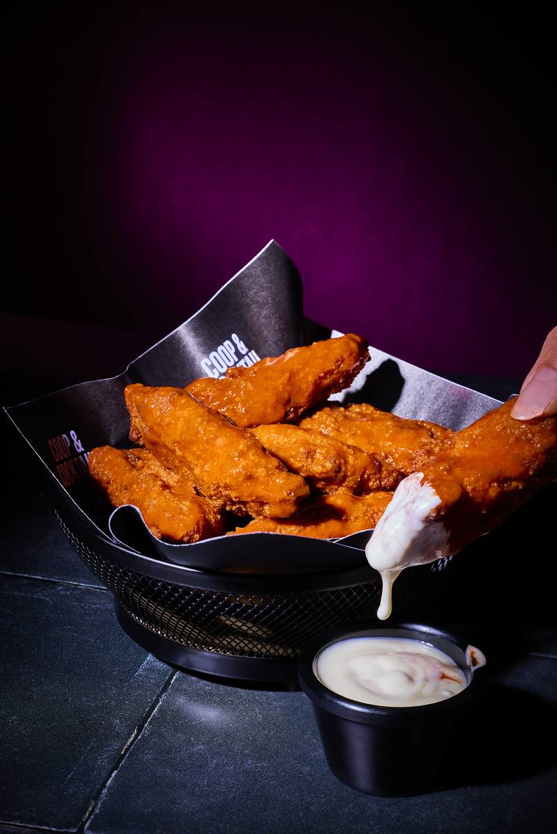 A tender being dunked into ranch
