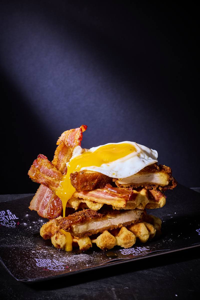 Chicken and waffle stack with a runny yolk